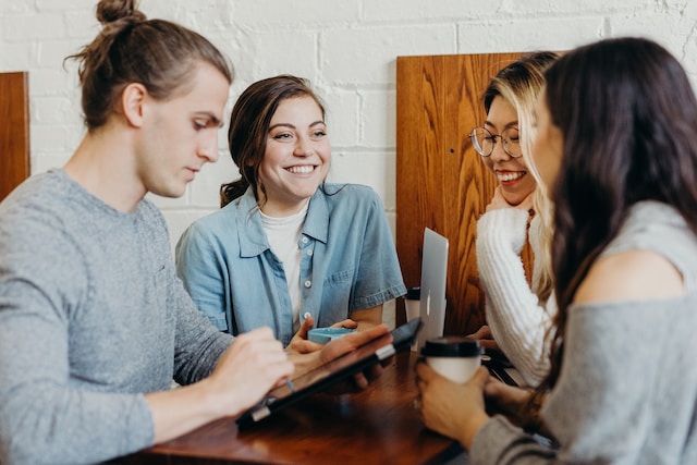 a group of young adults hanging out at a coffee shop